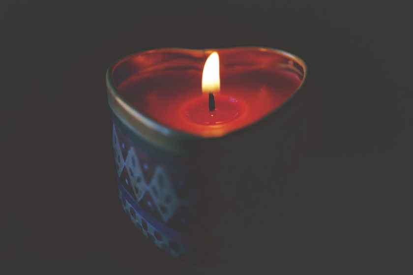 close up of tea light candle against black background