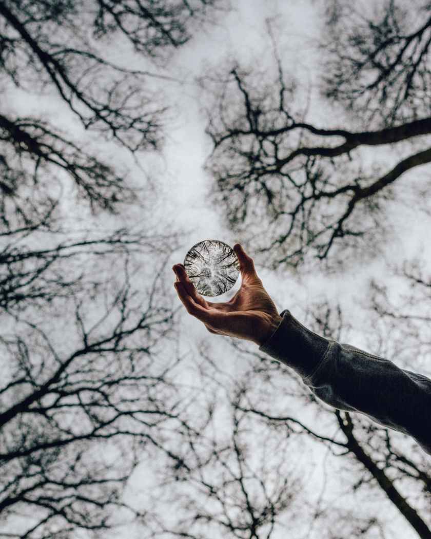 low angle photo of person holding crystal ball
